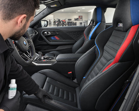 Wear shine on the seat bolster of a BMW M2 — shown in the article “What a car leather sealant protects and what it doesn't”