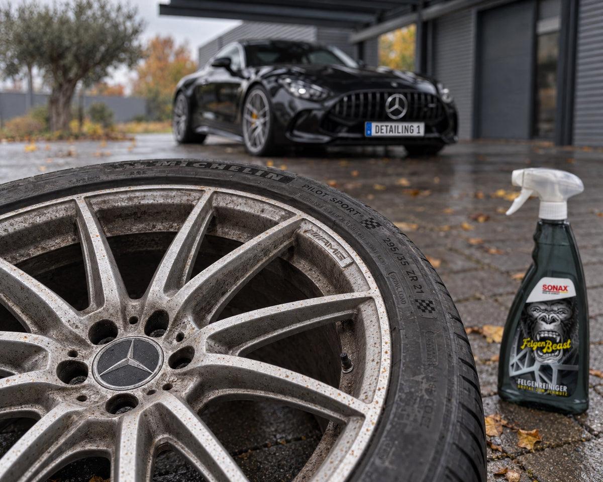 Removed wheel from a Mercedes-AMG GT 63 with brake dust and surface rust spots, SONAX FelgenBeast beside it